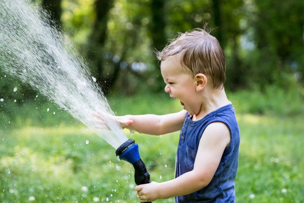 child playing with hose